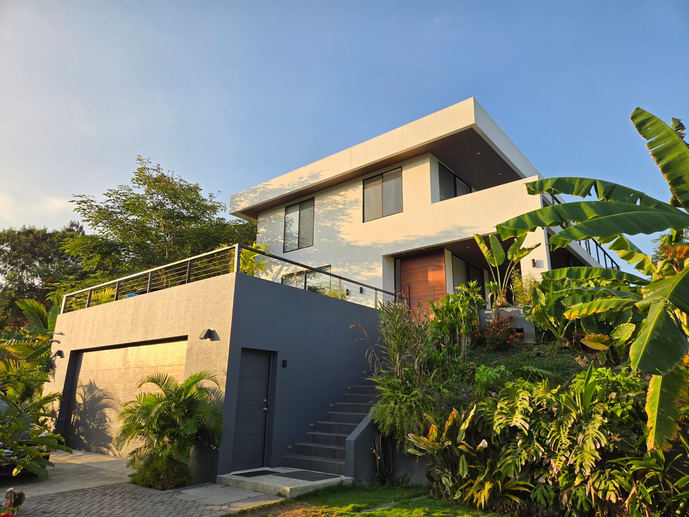 Two houses on one hillside, above the Pacific coast.